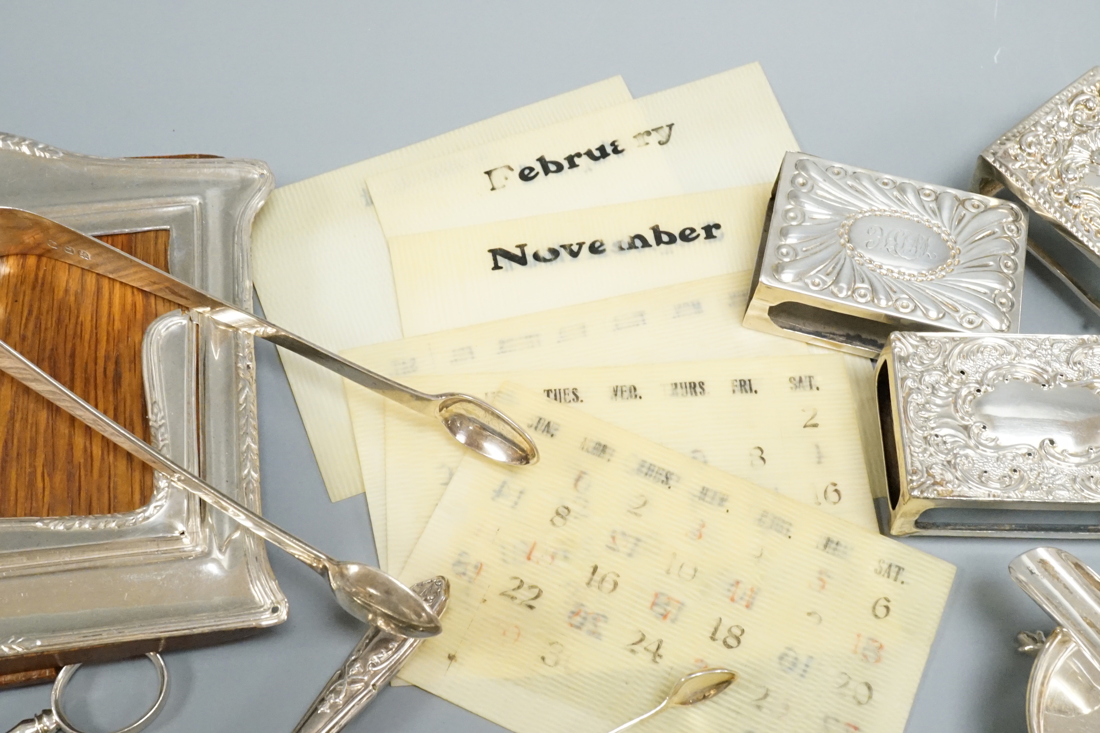 Sundry small silver including flatware, mounted calendar frame(a.f.), matchbox sleeves etc.